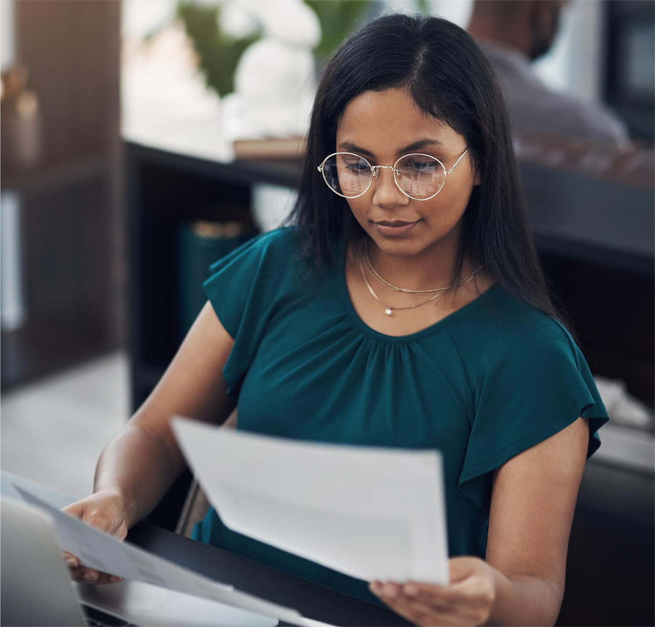 businesswoman going through ar aging report businesswoman going through ar aging report